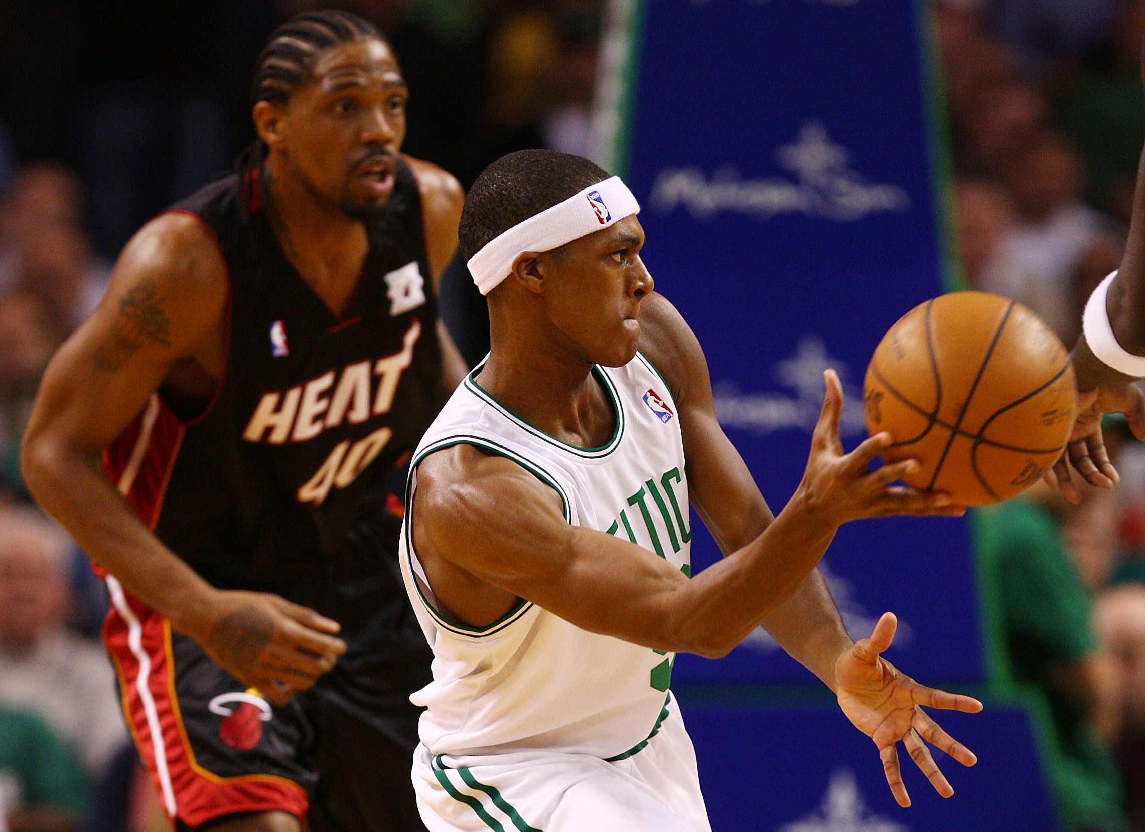 Rajon Rondo of the Boston Celtics passes the ball as Udonis Haslem of the Miami Heat defends.