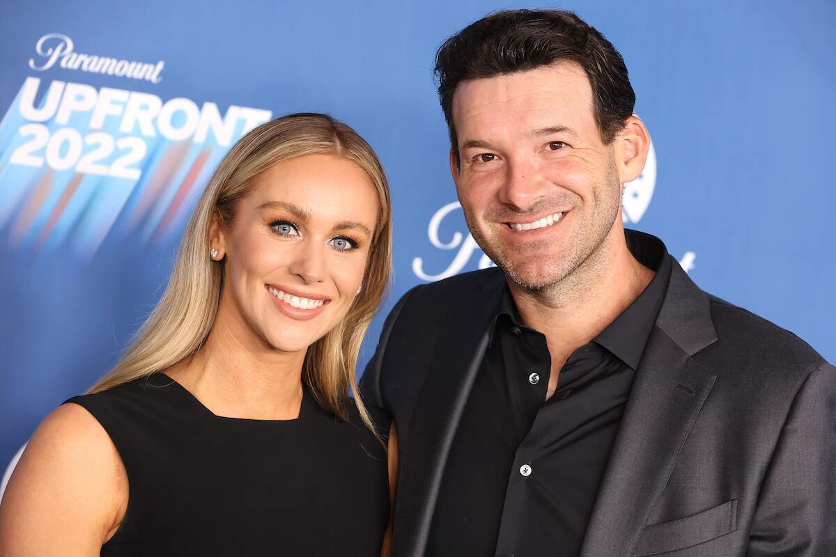 Candice Crawford and Tony Romo smile on the red carpet for the 2022 Paramount Upfront event