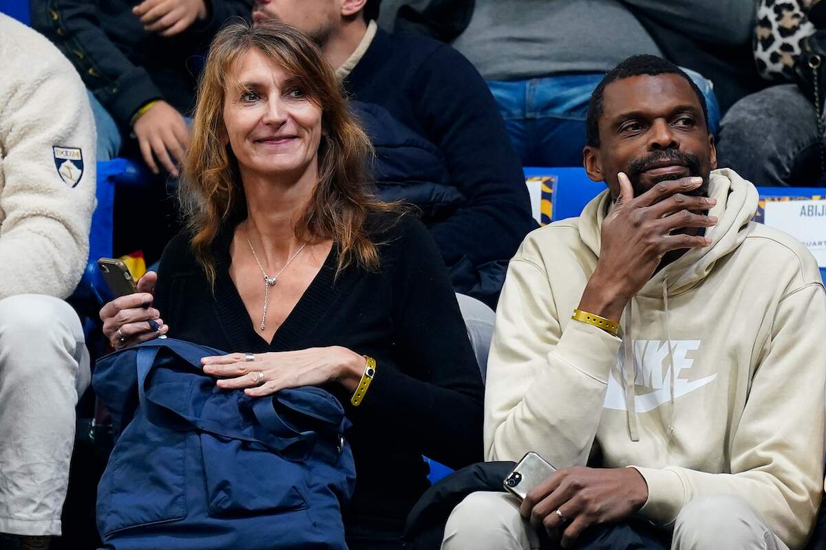 Elodie and Felix Wembanyama, Victor Wembanyama's parents, smile while watching a basketball game