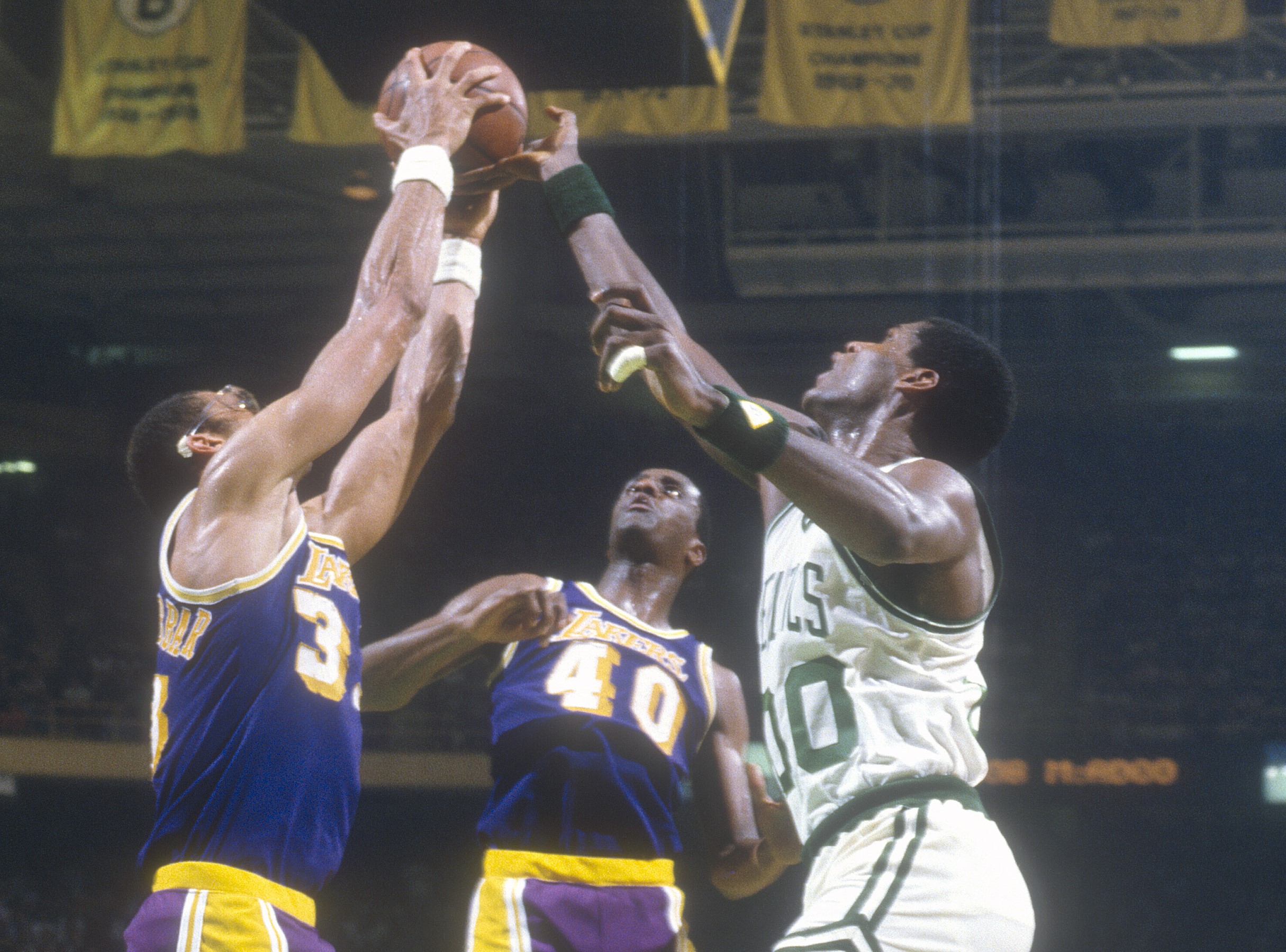 Kareem Abdul-Jabbar of the Los Angeles Lakers battles for a rebound with Robert Parish of the Boston Celtics.