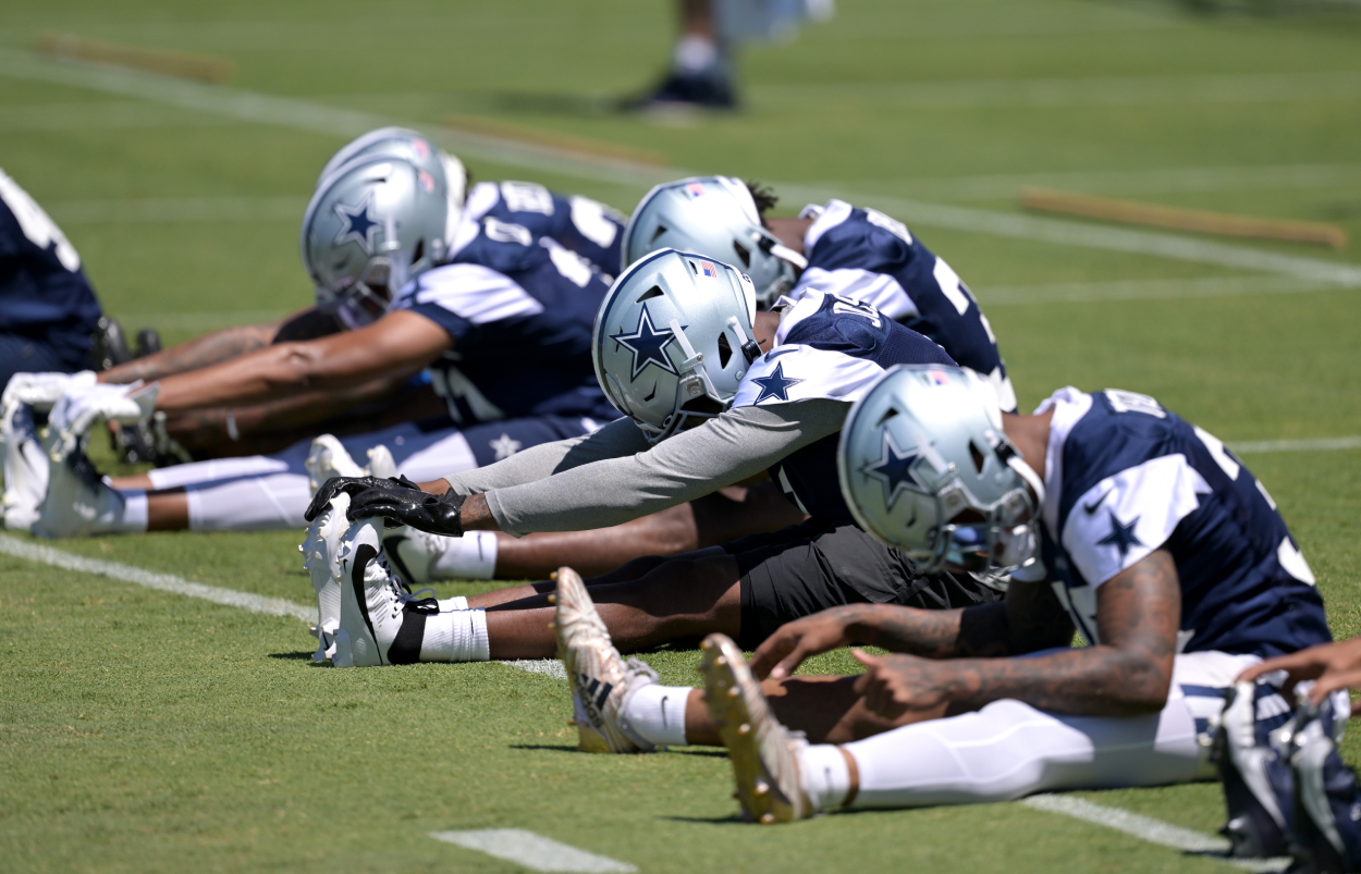 Dallas Cowboy players stretch during training camp.