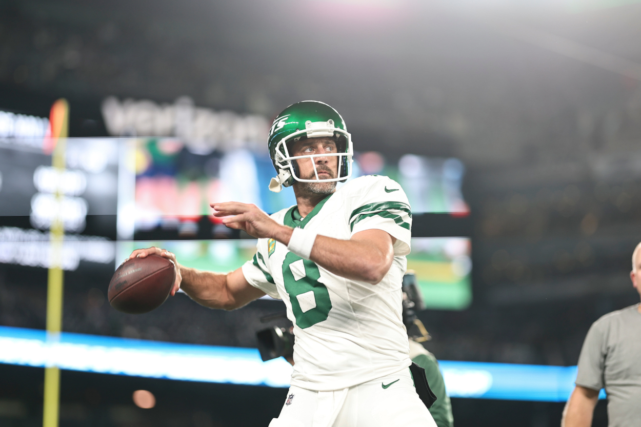 Aaron Rodgers of the New York Jets passes as he warms up prior to a game against the Buffalo Bills.