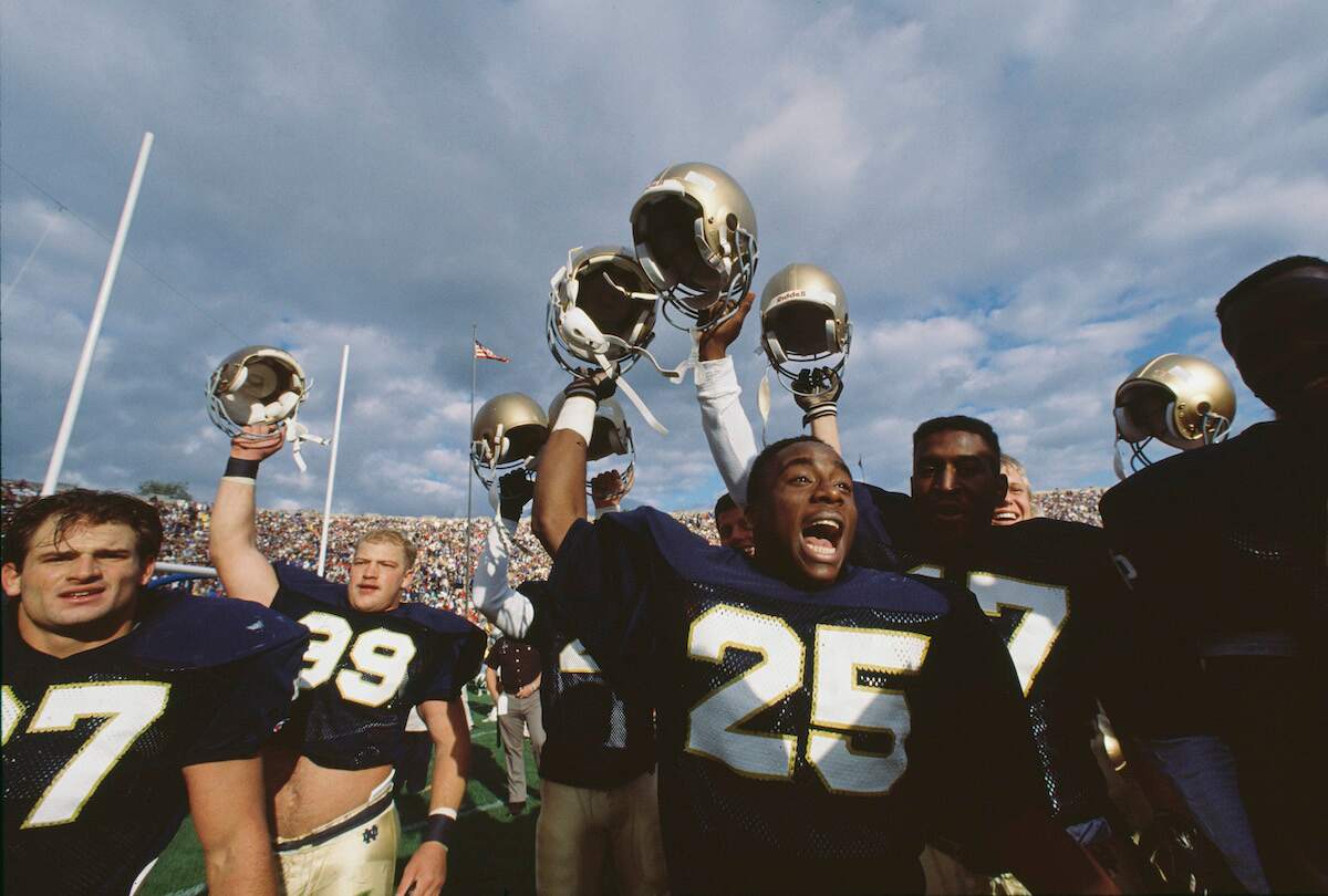 Wide receiver Raghib Ismail celebrates with his Notre Dame Fighting Irish teammates after winning the NCAA Big Ten Conference college football game against the Purdue University Boilermakers in 1988