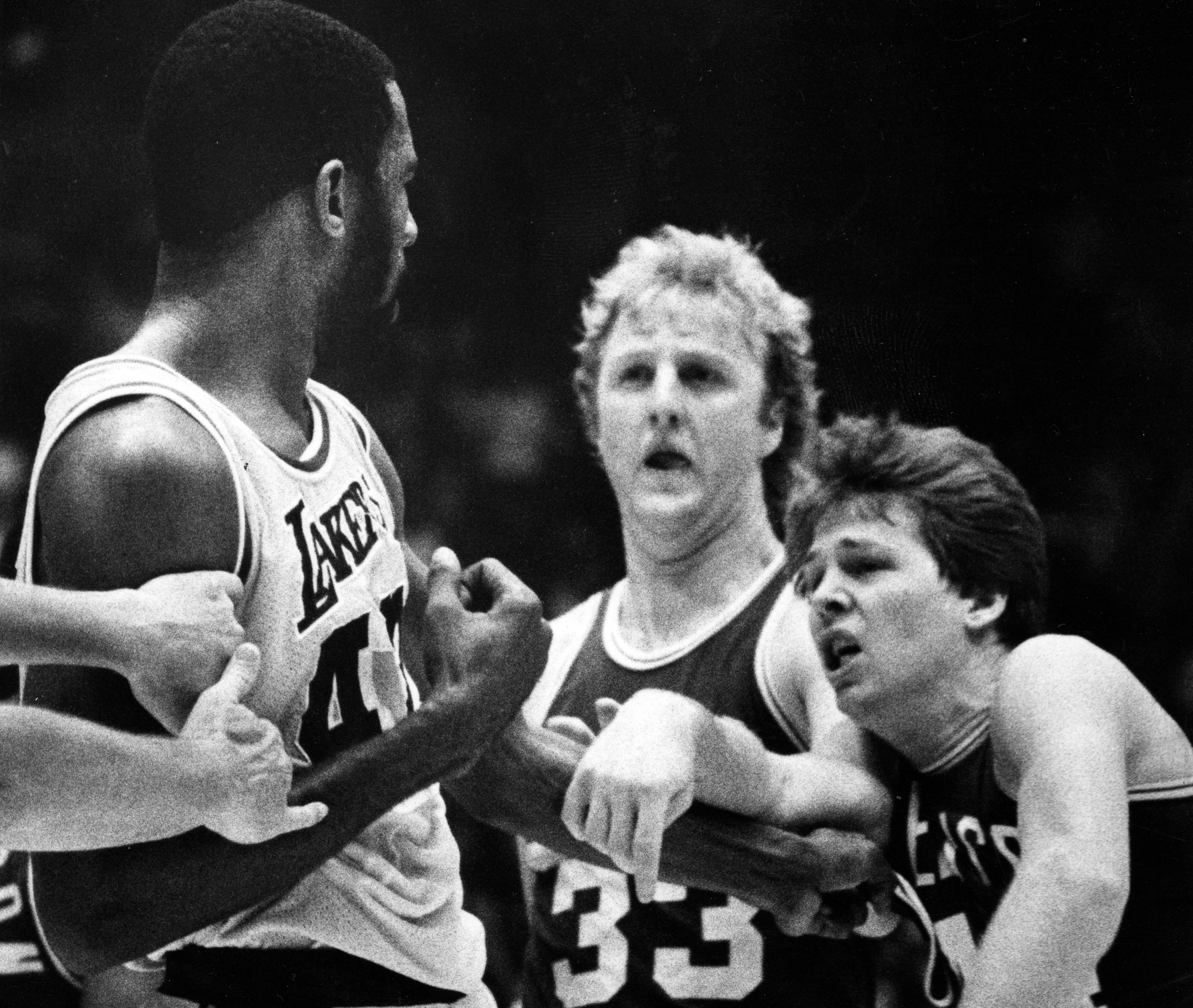 A scuffle erupts between Boston Celtics guard Danny Ainge, right, and Lakers forward James Worthy as Boston's Larry Bird steps in between.