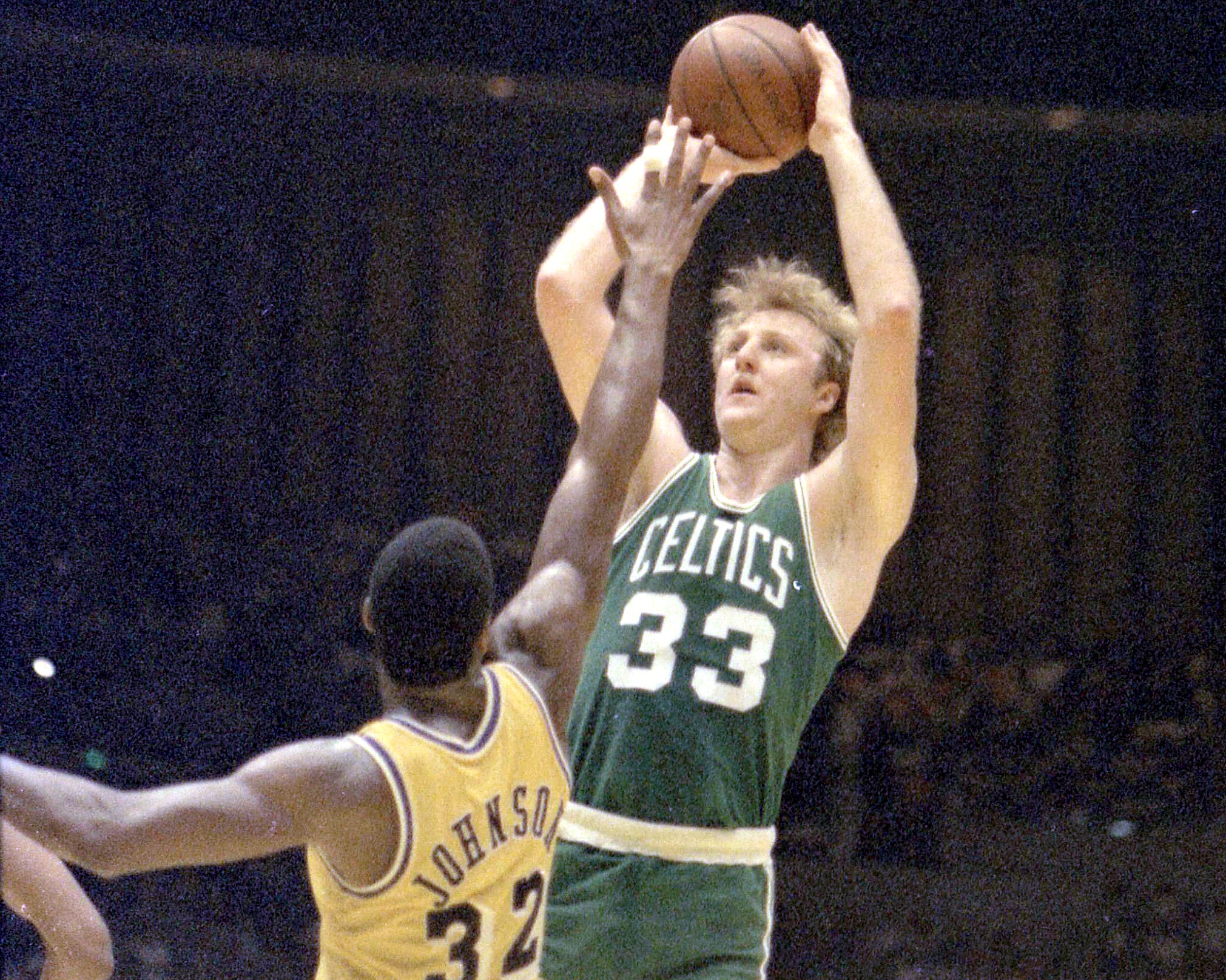 Boston Celtics forward Larry Bird shoots a jumper over Los Angeles Lakers guard Magic Johnson.