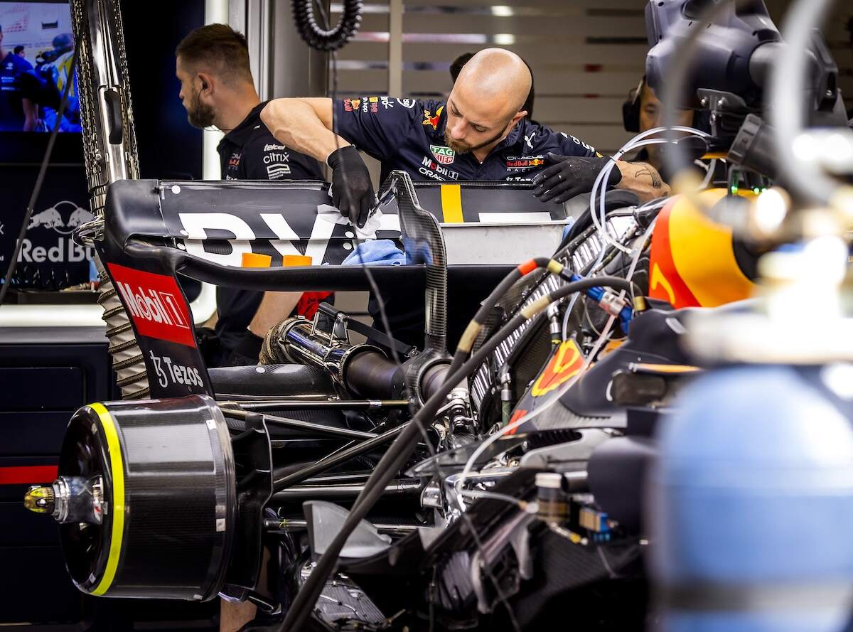 Red Bull Racing engineers work on the rear wing of Max Verstappen's car whose DRS, the movable section, failed