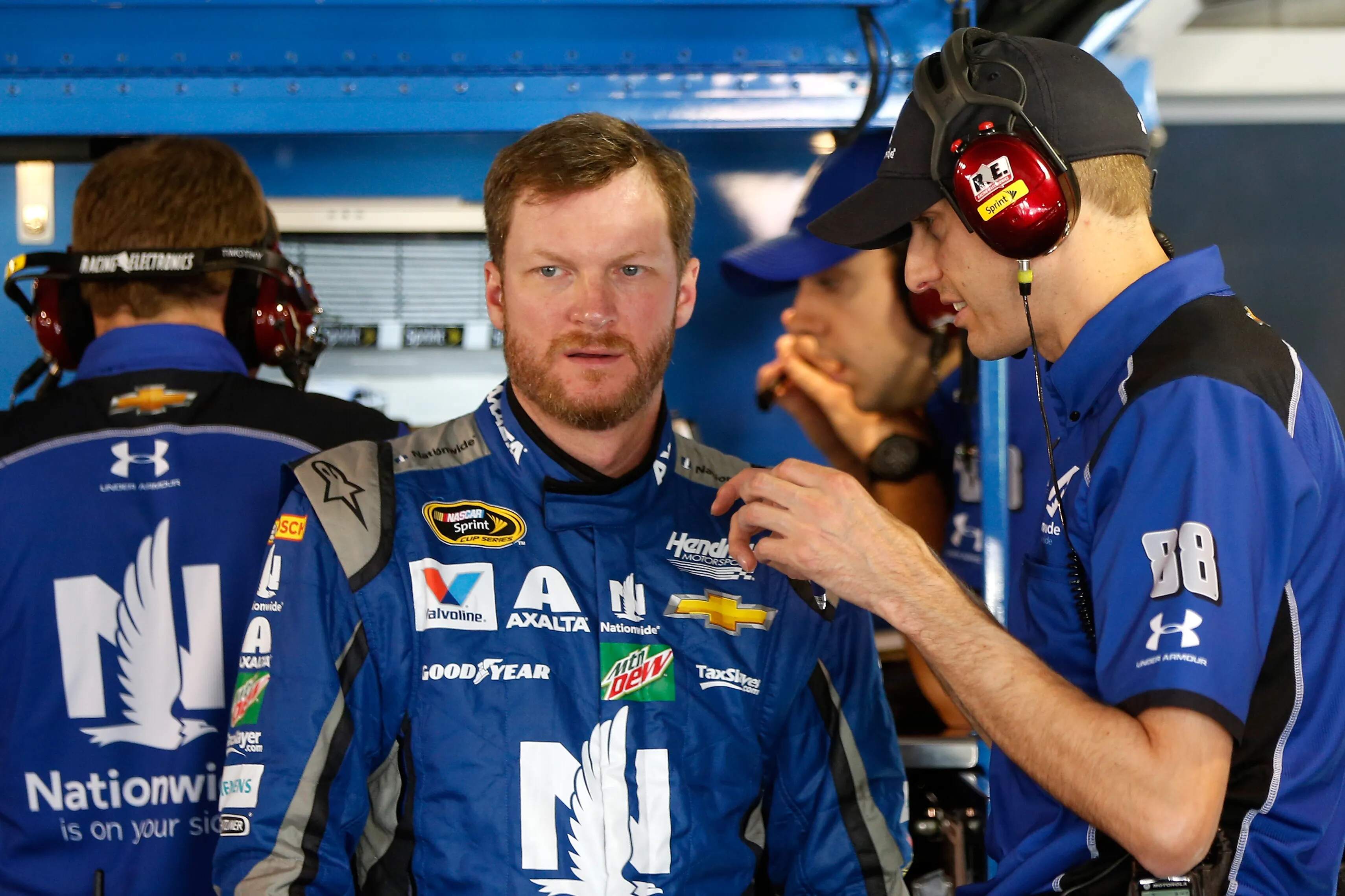 Dale Earnhardt Jr., driver of the #88 Nationwide Chevrolet, talks with a crew member in 2016