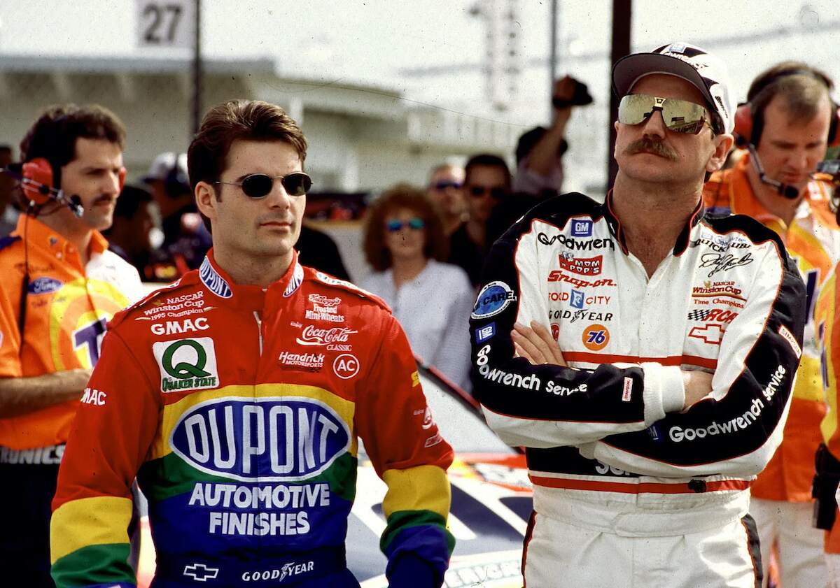 Dale Earnhardt Sr. stands alongside fellow NASCAR driver Jeff Gordon