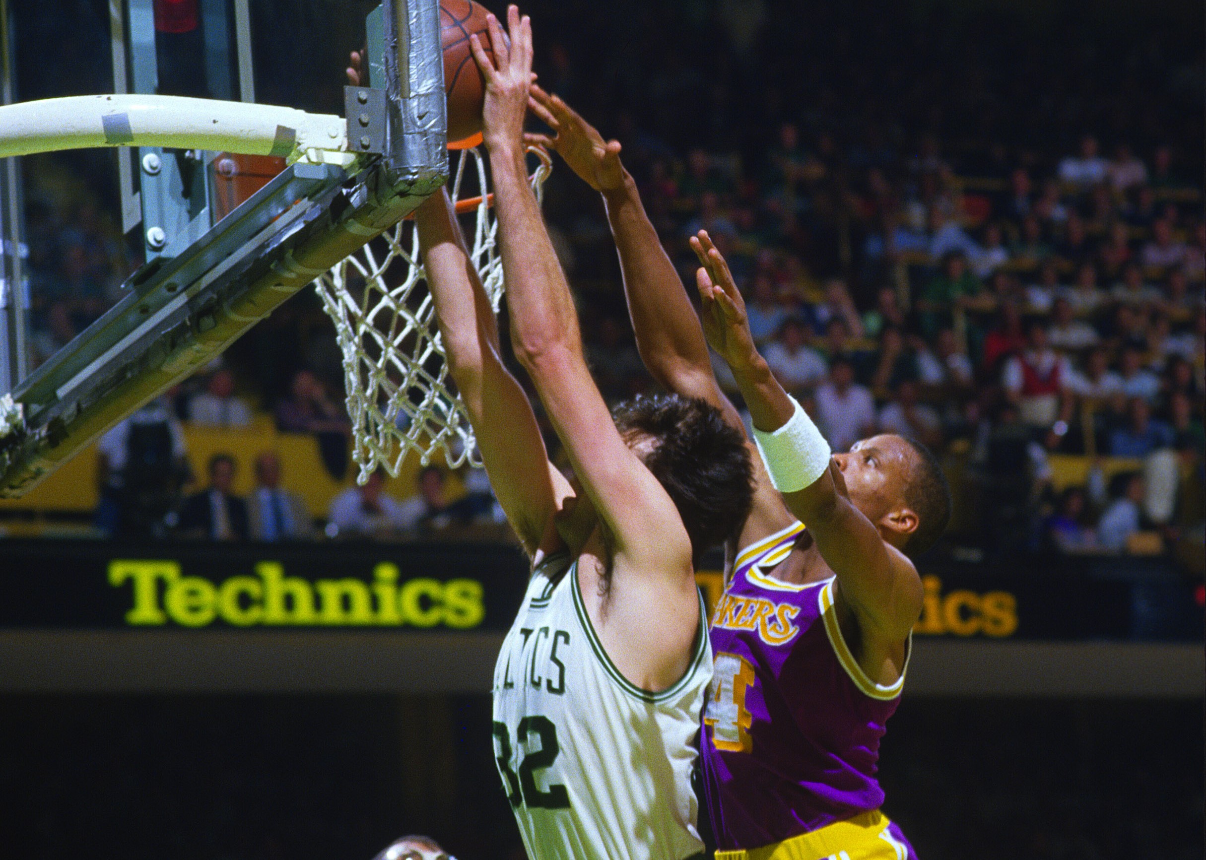Kevin McHale of the Boston Celtics goes up to grab a rebound over Byron Scott of the Los Angeles Lakers.