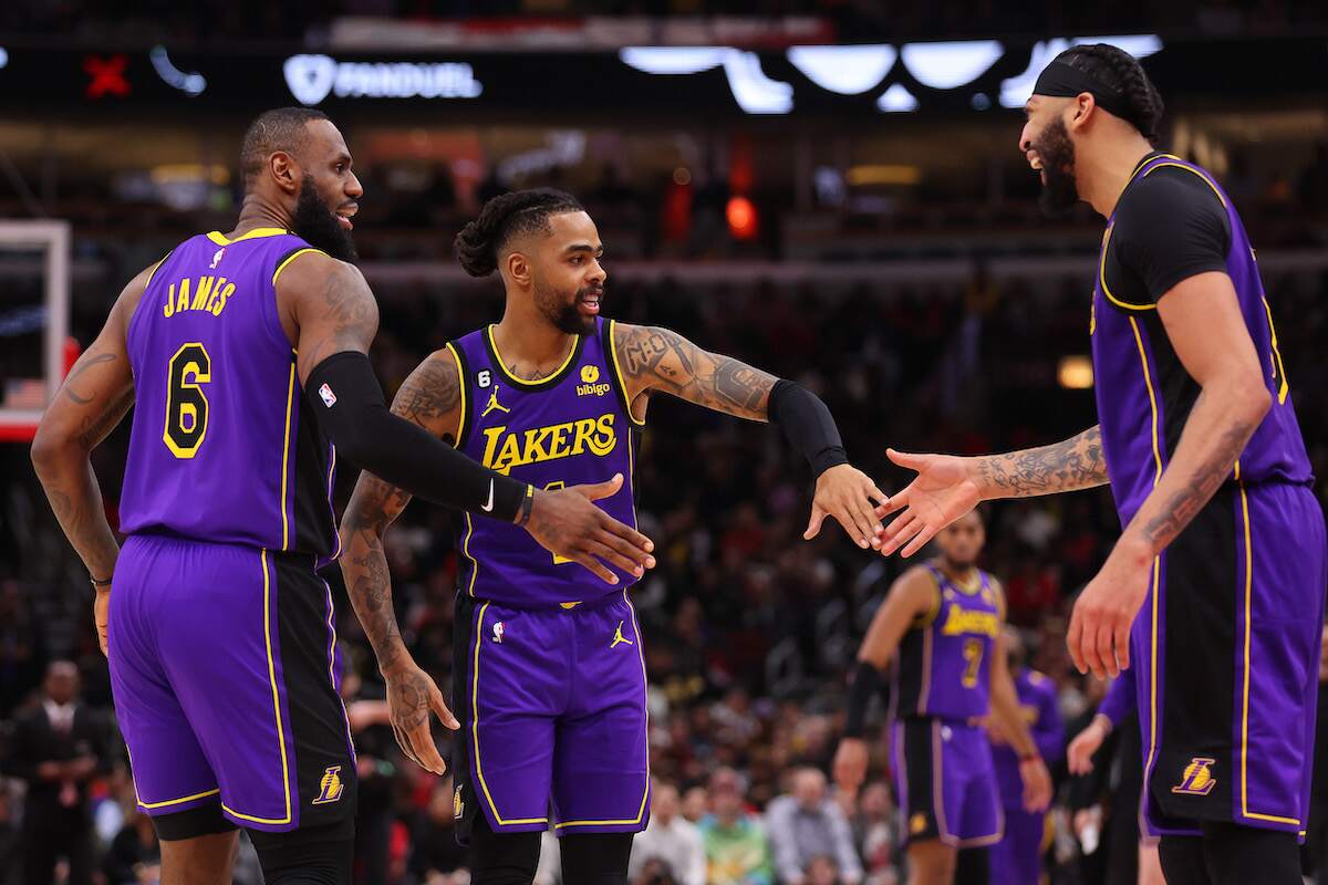 LeBron James, D'Angelo Russell, and Anthony Davis of the Los Angeles Lakers celebrate during a 2023 game