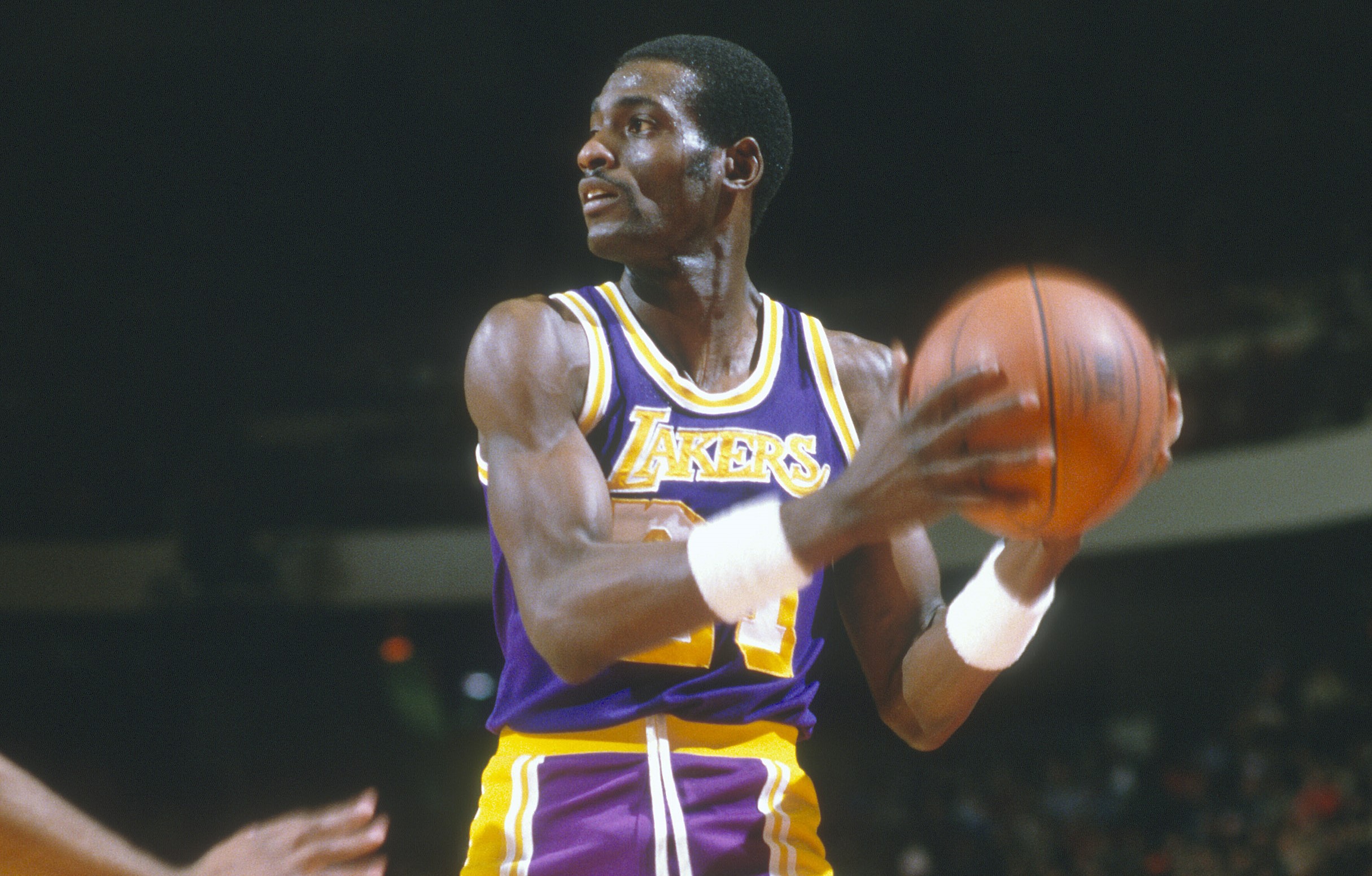 Michael Cooper of the Los Angeles Lakers looks to pass the ball against the Boston Celtics.