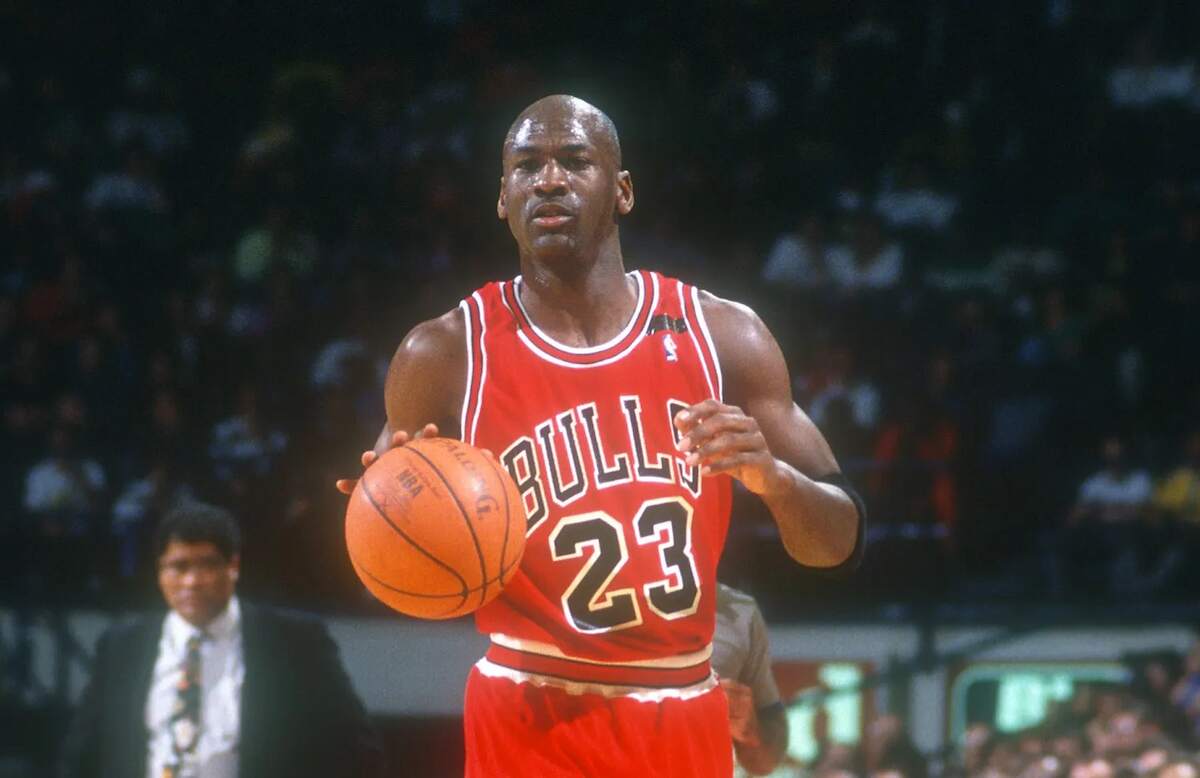 NBA legend Michael Jordan looks to pass the basketball during a Chicago Bulls game