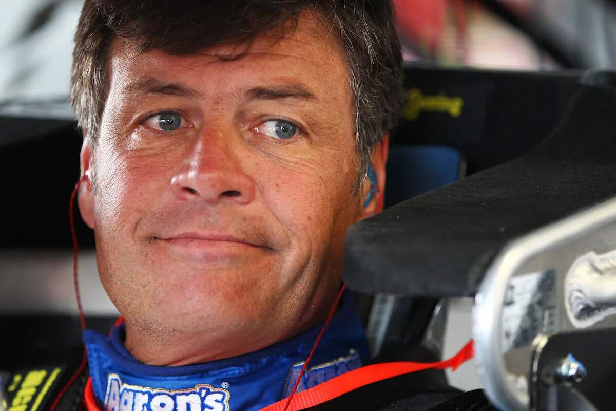 NASCAR driver Michael Waltrip looks out from his racecare in 2013