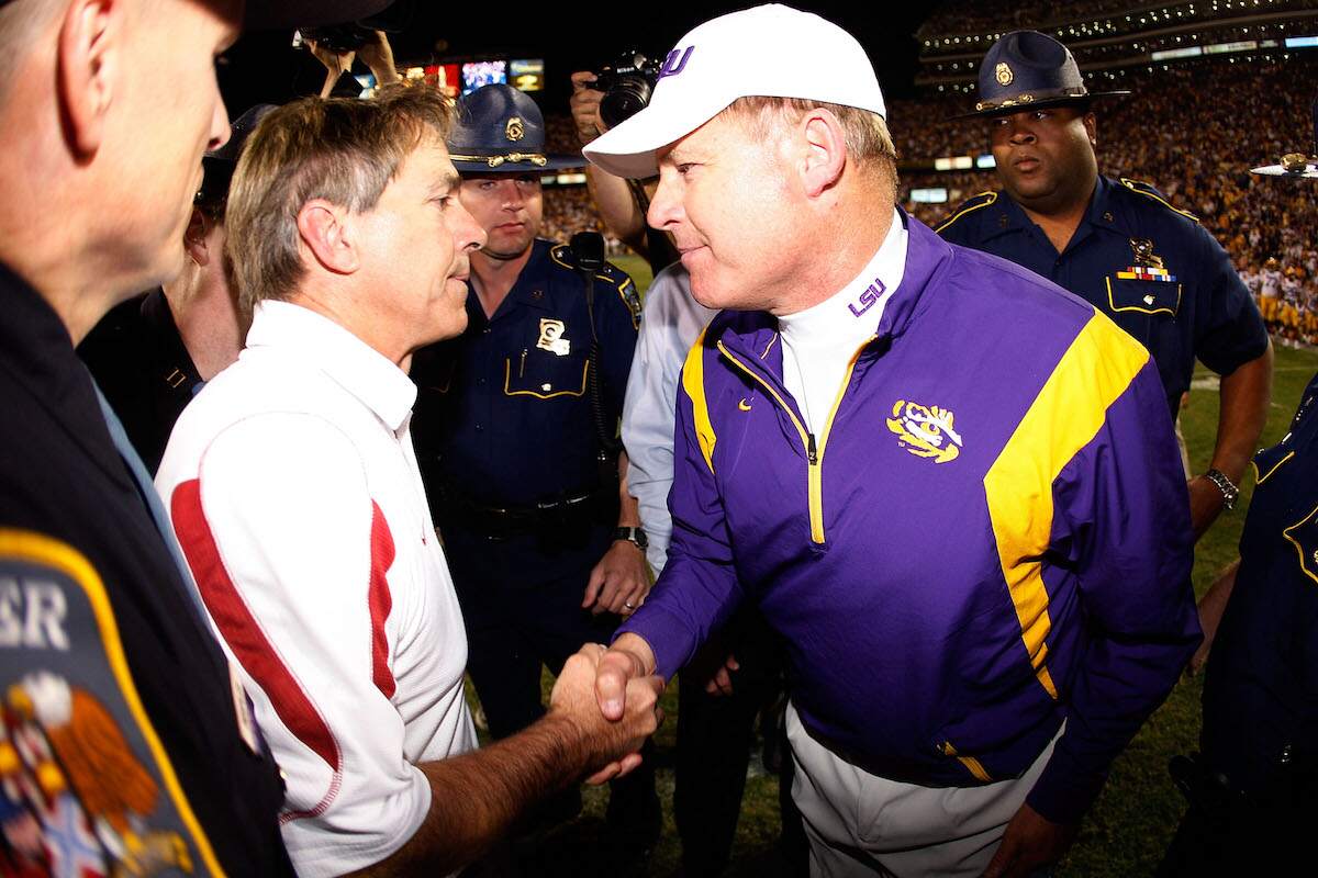Head coach Nick Saban of the Alabama Crimson Tide is congratulated by head coach Les Miles of the Louisiana State University Tigers after the Tide defeated the Tigers 27-21 in overtime on November 11, 2008 at Tiger Stadium in Baton Rouge, Louisiana