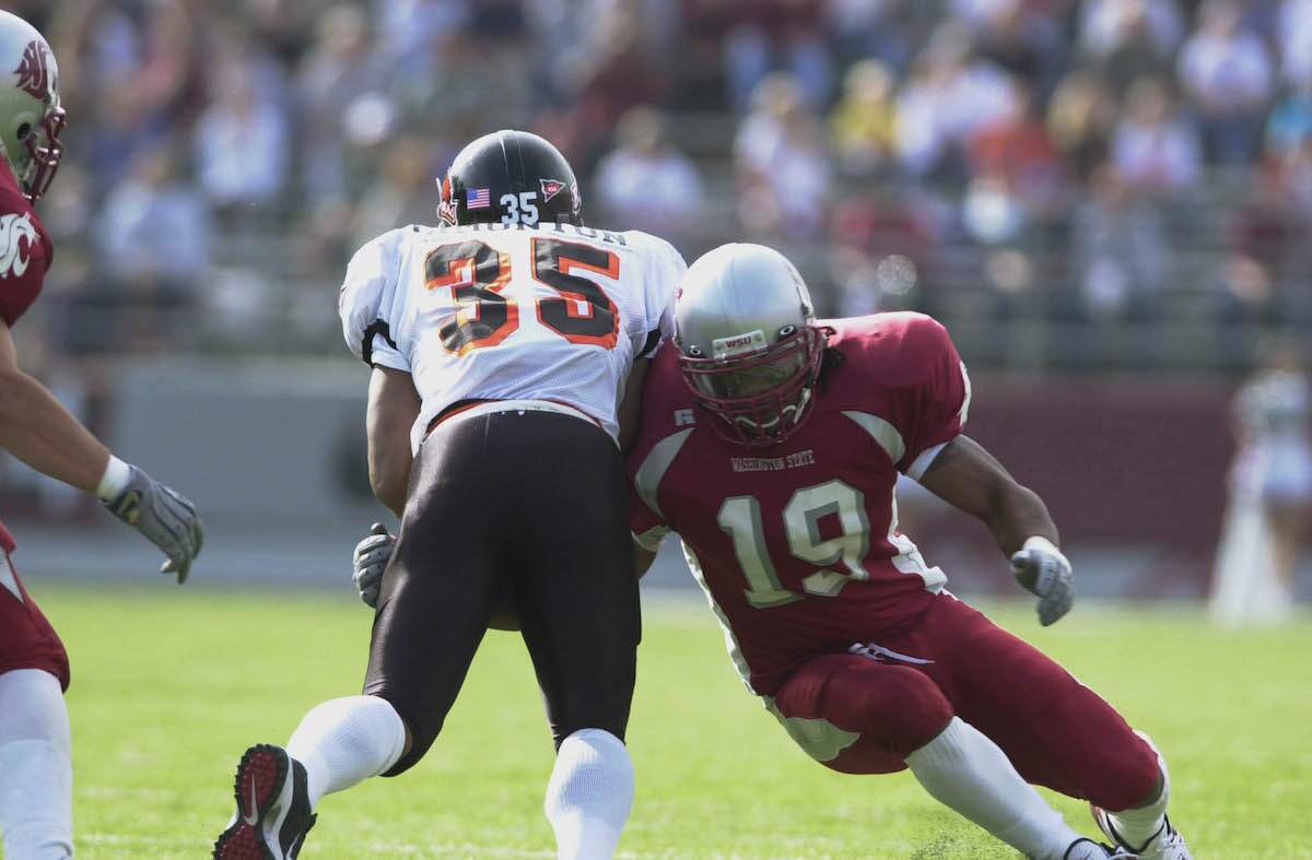 Lamont Thompson of Washington State blocks Ken Simonton of Oregon State during a game at Martin Stadium in Pullman, Washington