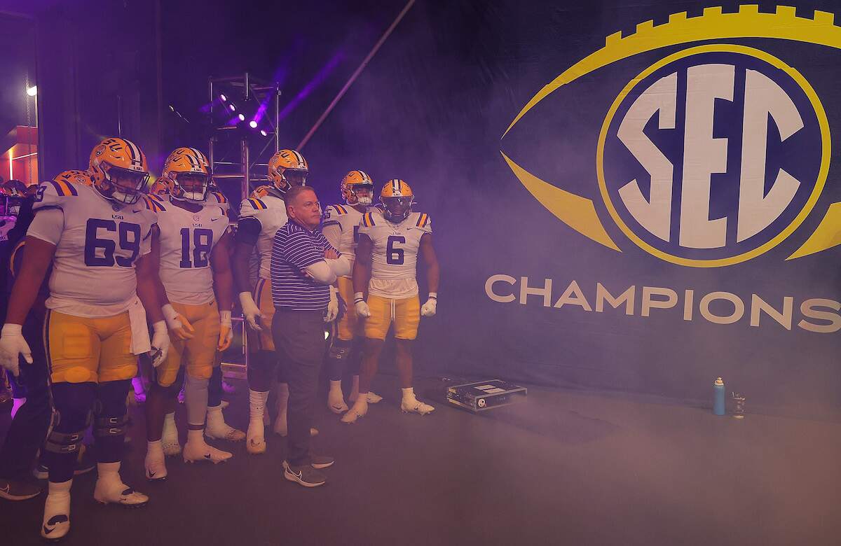 Head coach Brian Kelly of the LSU Tigers stands with his team prior to facing the Georgia Bulldogs in the 2022 SEC Championship