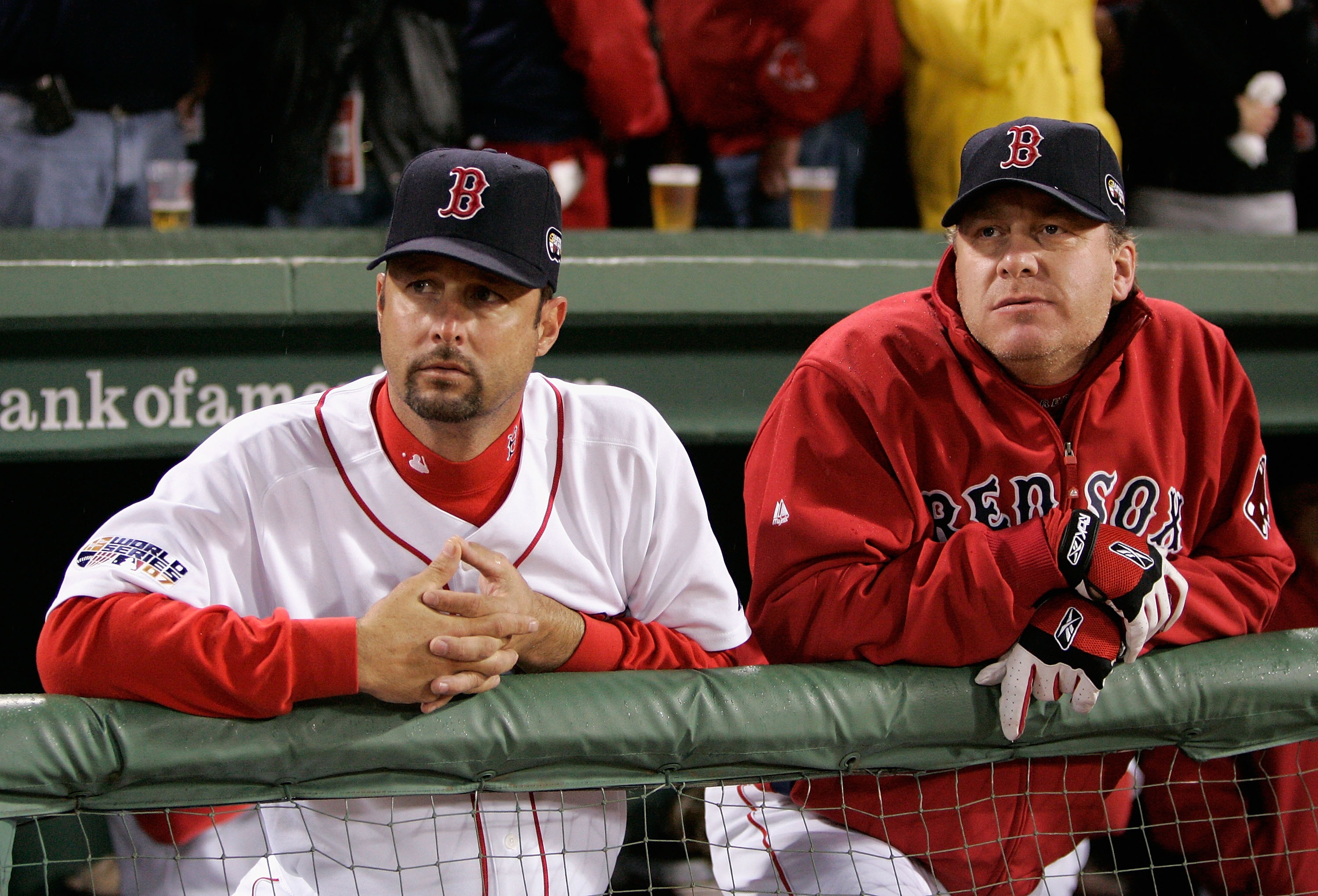 Pitchers Tim Wakefield, left, and Curt Schilling of the Boston Red Sox look on from the dugout.