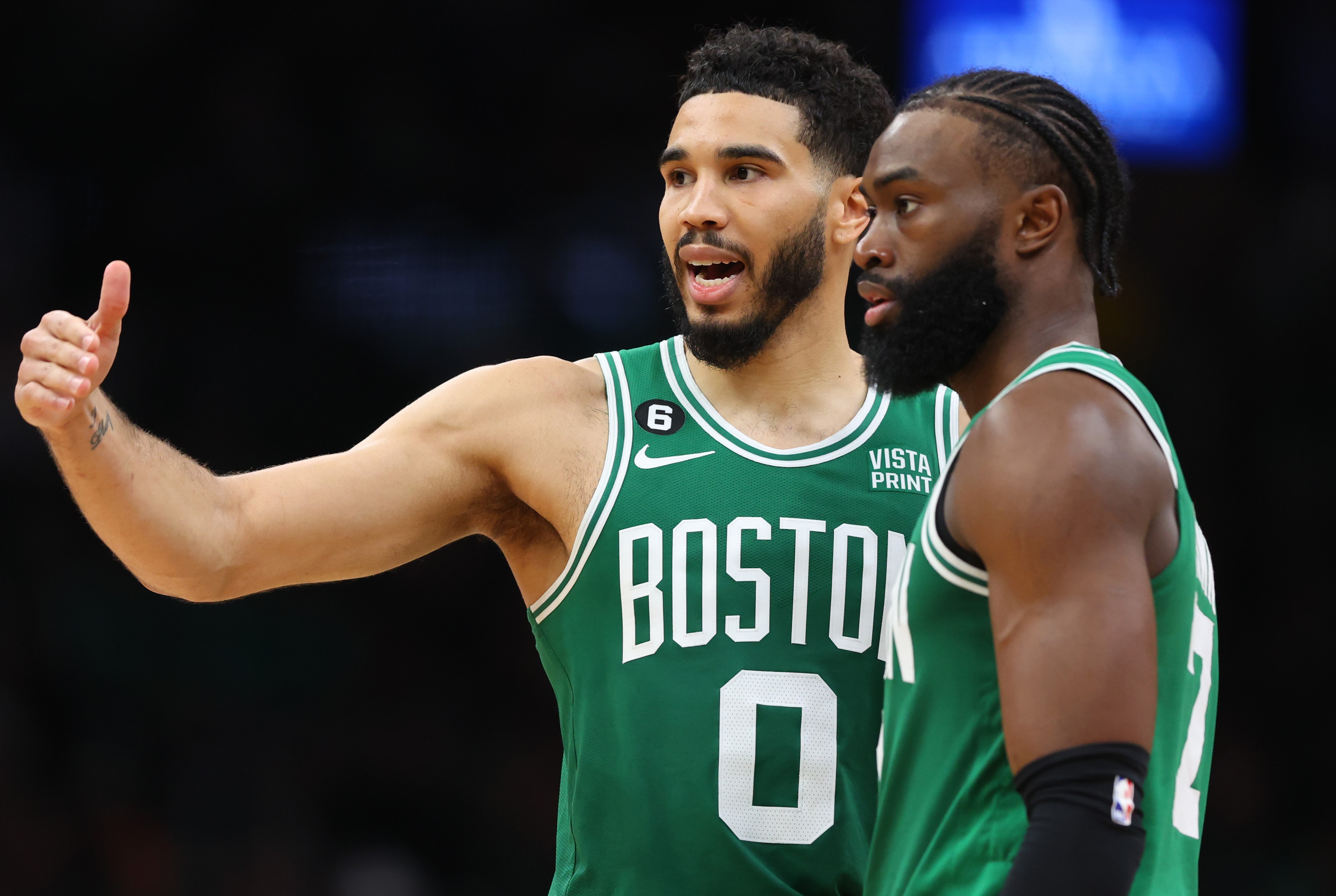 Boston Celtics star Jayson Tatum talks with Jaylen Brown.
