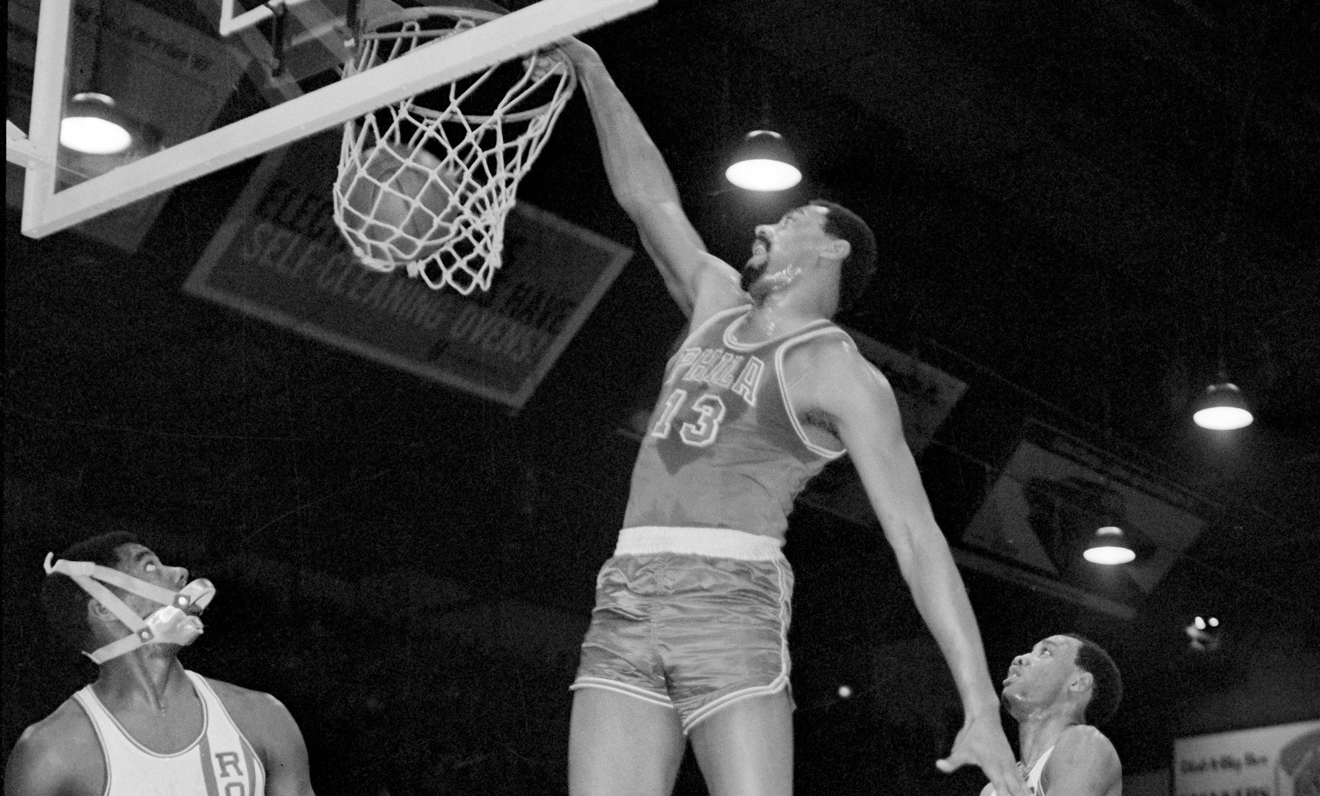 Wilt Chamberlain of the Philadelphia 76ers dunks in the first quarter against the Cincinnati Royals.