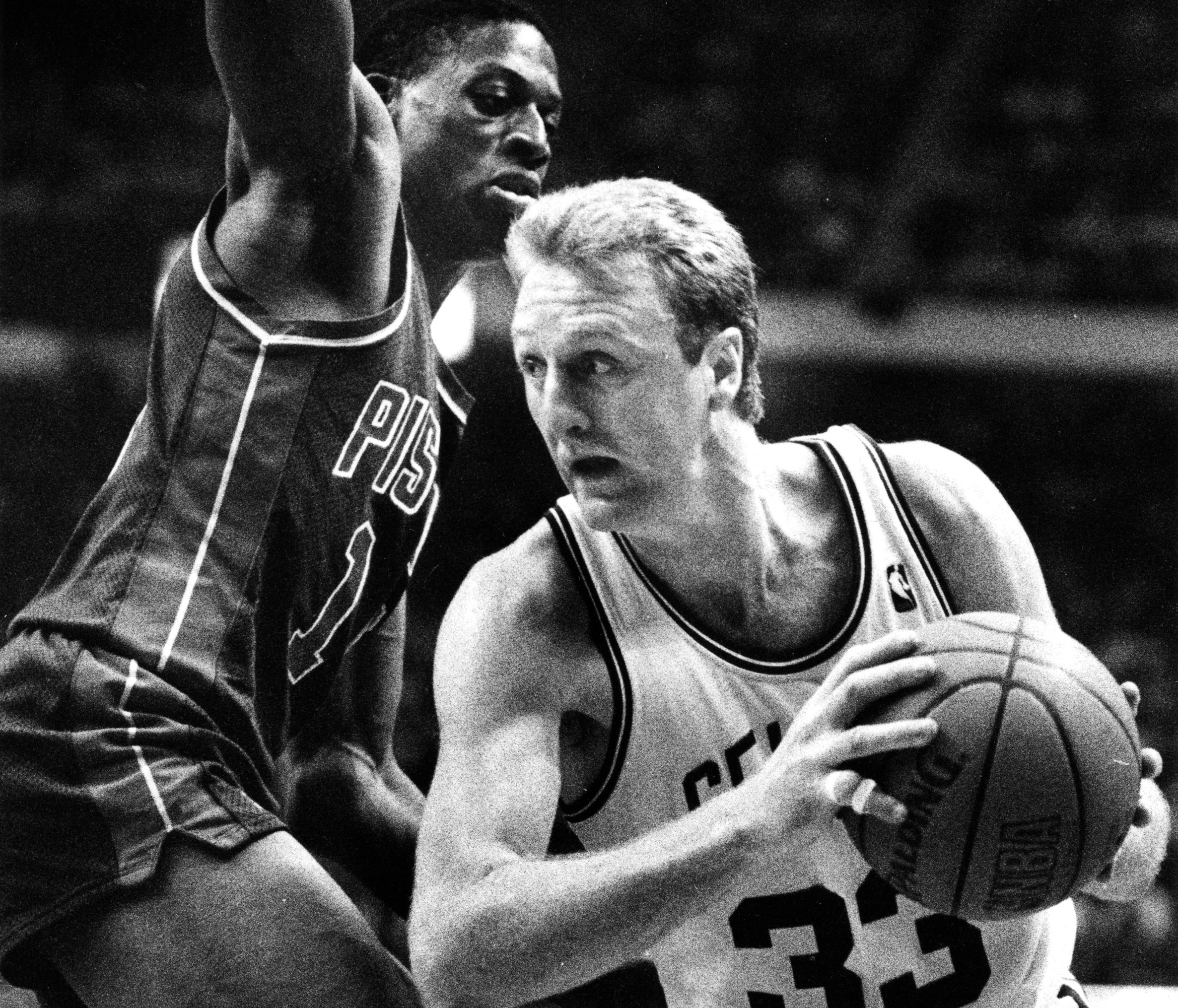 Boston Celtics star Larry Bird drives past Detroit's Dennis Rodman.