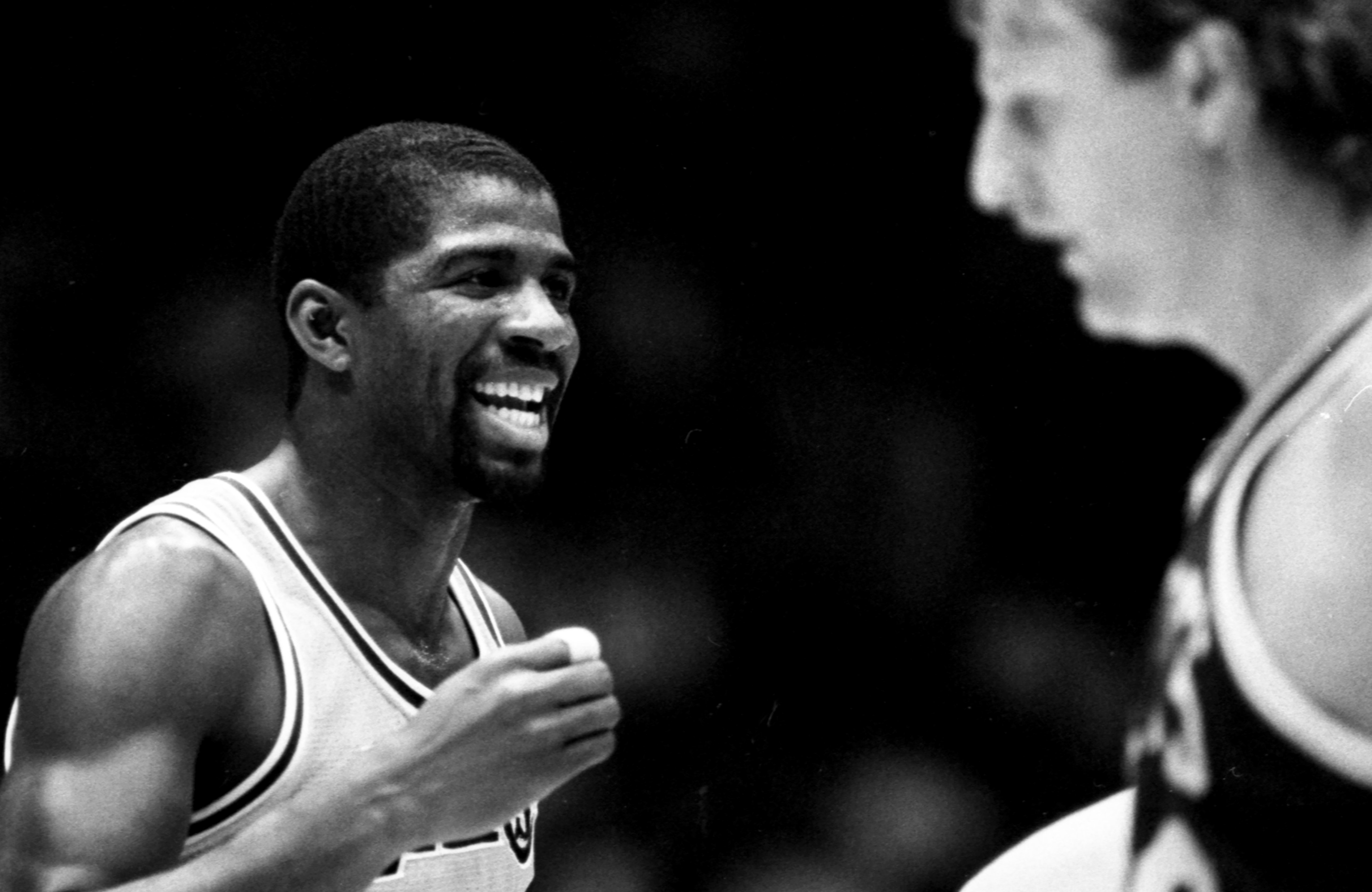 Earvin Magic Johnson of the Los Angeles Lakers reacts to a call as Larry Bird of the Boston Celtics looks on.