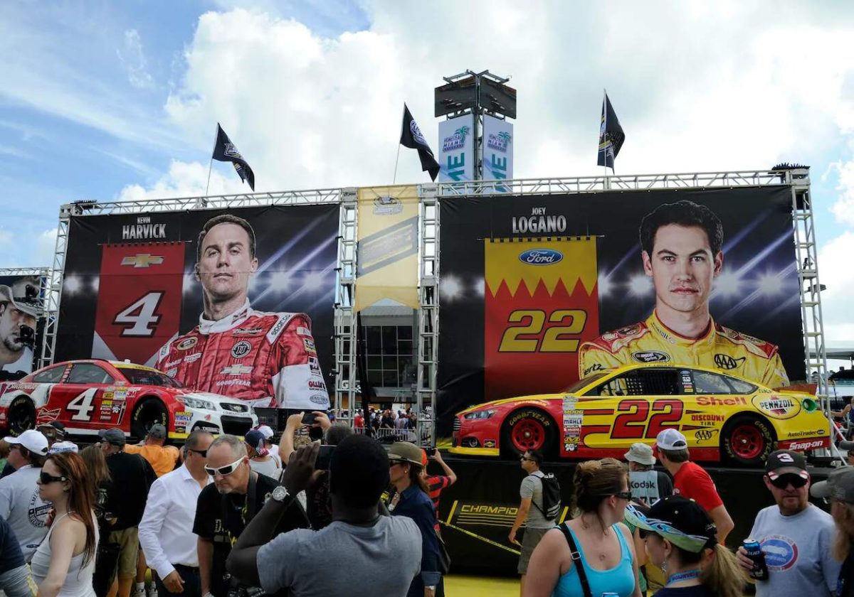 Posters of rivals Kevin Harvick and Joey Logano's faces at a NASCAR event