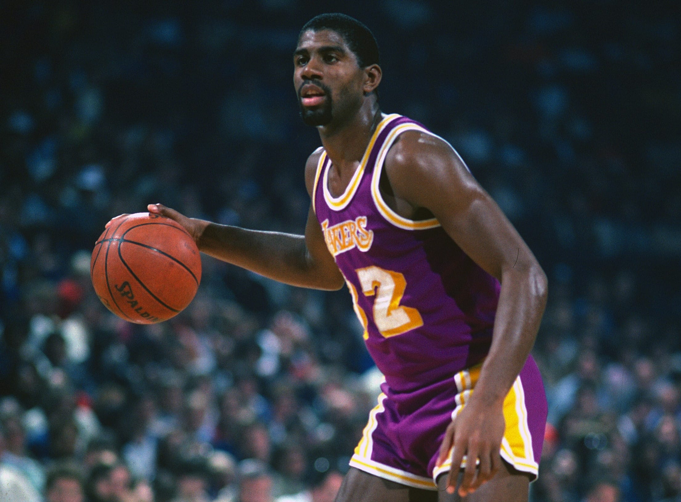 Earvin Magic Johnson of the Los Angeles Lakers dribbles the ball.