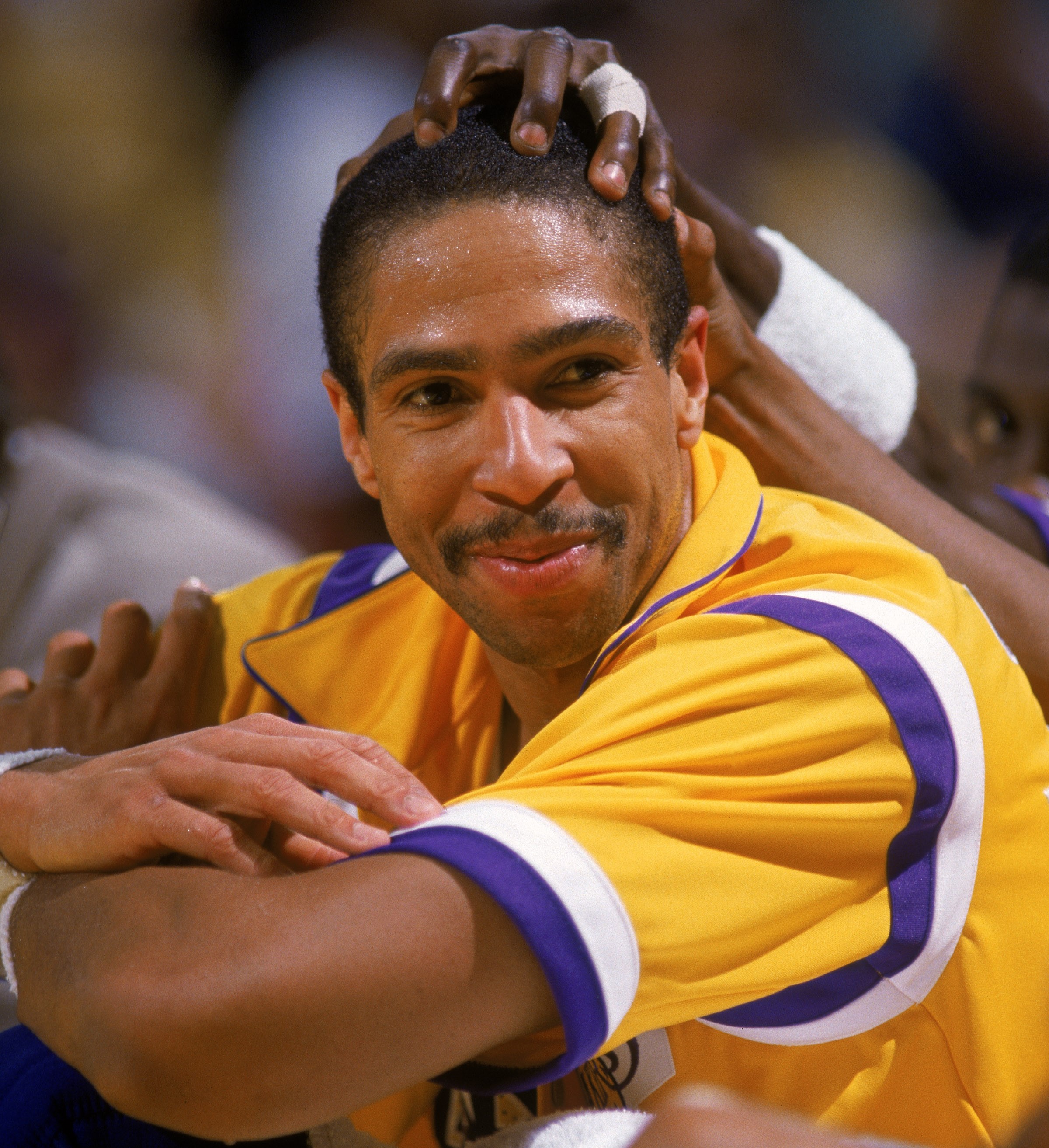 Mychal Thompson of the Los Angeles Lakers smiles on the bench.