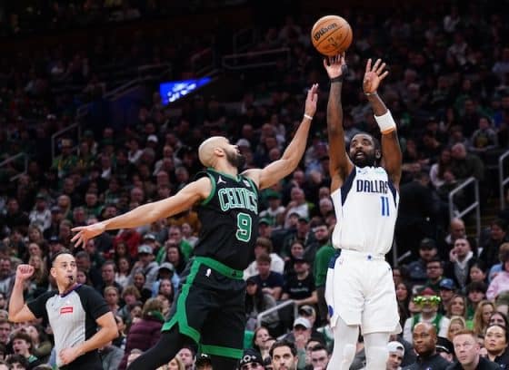 Derrick White contests a shot by Kyrie Irving.