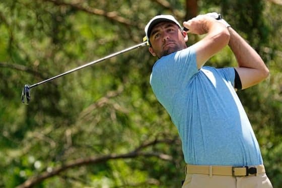 Scottie Scheffler swings a club.