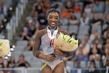 Simone Biles of World Champions Centre poses for a photo with her gold medal.