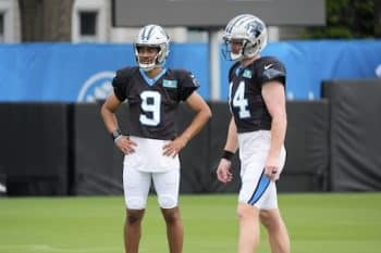Andy Dalton stands next to Bryce Young.