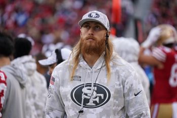 George Kittle stands on the sideline with injury against the Seattle Seahawks.