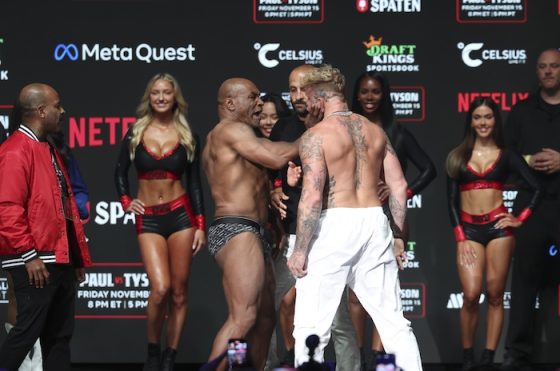 Mike Tyson (left) slaps Jake Paul (right) after weighing in.