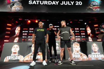 Jake Paul and Mike Tyson pose and stand next to each other.