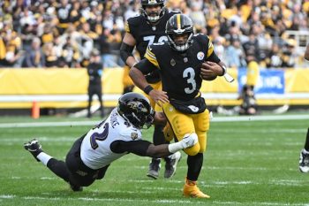 Pittsburgh Steelers quarterback Russell Wilson runs away from Baltimore Ravens defensive tackle Nnamdi Madubuike.