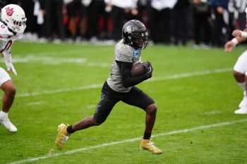 Travis Hunter carries the ball.