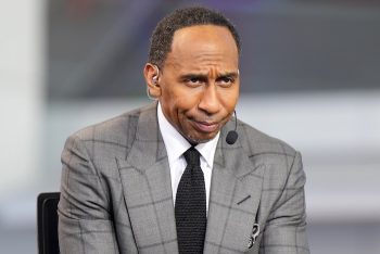 Stephen A. Smith sits at a desk and stares.