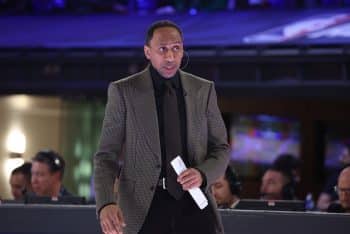 Stephen A. Smith stands on the sideline.