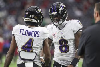 Lamar Jackson and Zay Flowers shake hands at midfield.