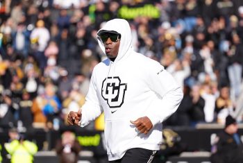 Colorado Buffaloes head coach Deion Sanders runs onto the field.