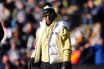 Colorado Buffaloes head coach Deion Sanders stands on the field.