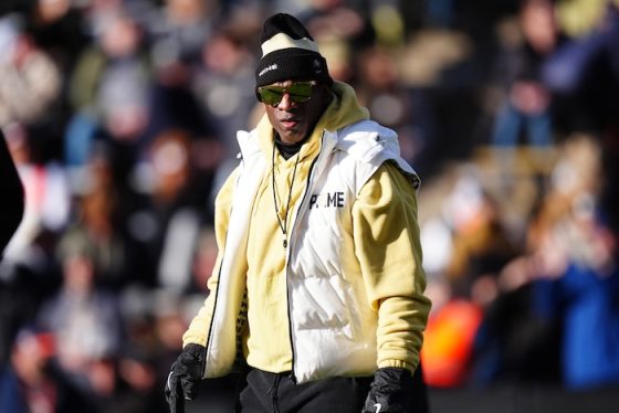 Colorado Buffaloes head coach Deion Sanders stands on the field.