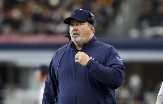 Mike McCarthy walks down the sideline.