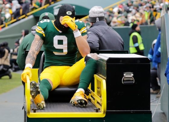 Green Bay Packers wide receiver Christian Watson sits on a cart.