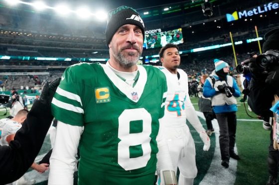 New York Jets quarterback Aaron Rodgers walks on field.