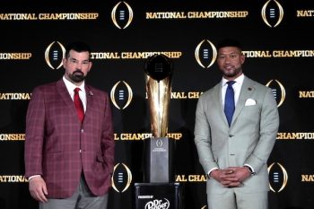 Ohio State Buckeyes head coach Ryan Day and Notre Dame Fighting Irish head coach Marcus Freeman stand in front of the trophy.