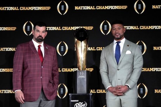 Ohio State Buckeyes head coach Ryan Day and Notre Dame Fighting Irish head coach Marcus Freeman stand in front of the trophy.