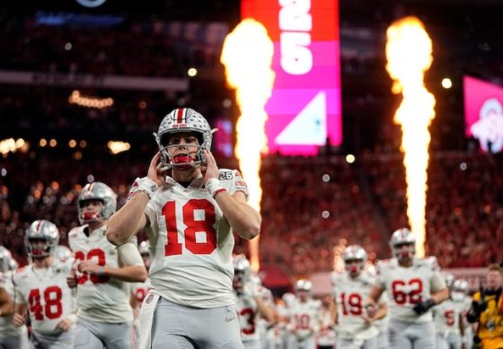 Ohio State Buckeyes quarterback Will Howard holds his helmet.