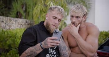 The Paul Brothers look at a phone in Paul American.